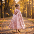 Girl in the Rose Gold Sequined Cape with the hood up, back view on an autumn path