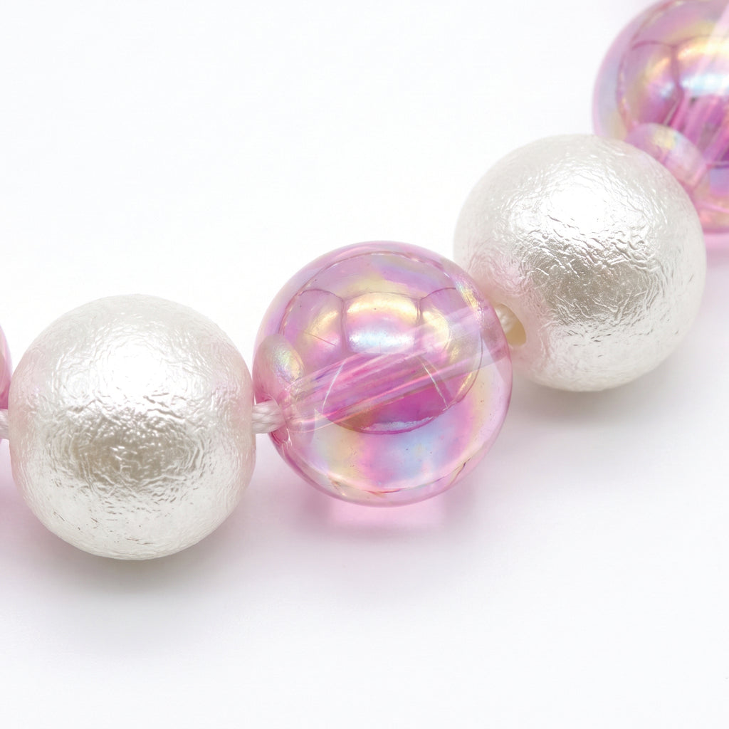 Close up of the white pearl and iridescent pink beads
