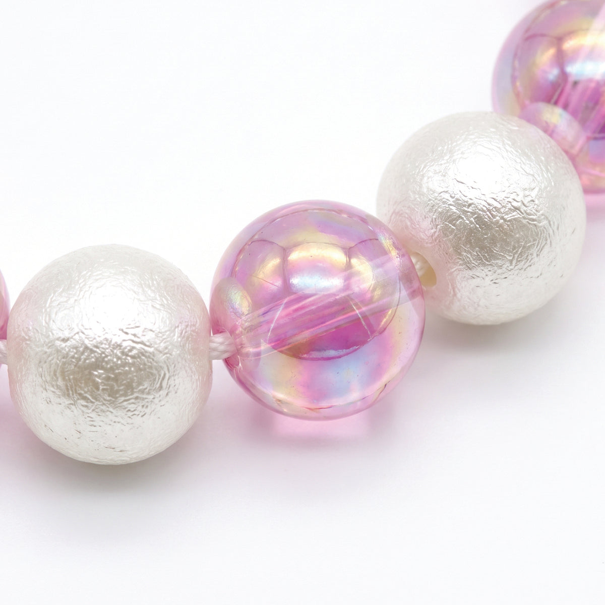 Close up of the white pearl and iridescent pink beads
