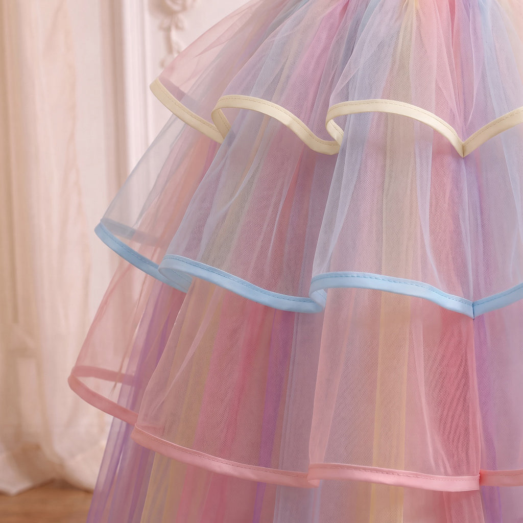 Close up of the three ribbon-edged ruffle tiers in cream, sky blue and pink over rainbow striped tulle