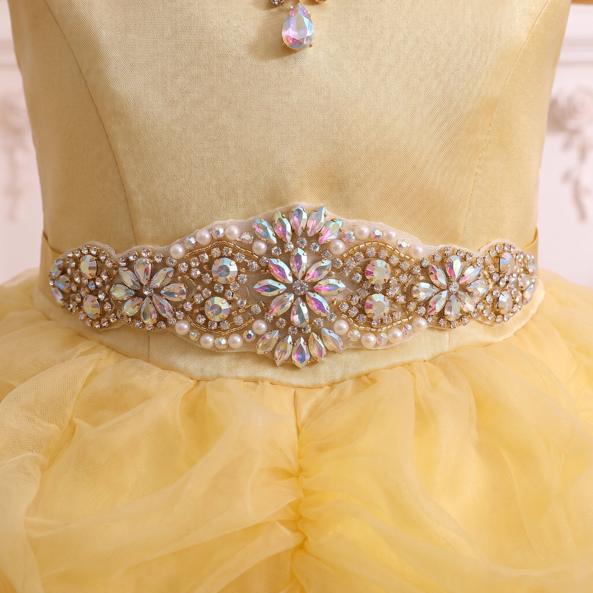 Close up of the jeweled belt of pearls, iridescent stones and crystal flowers