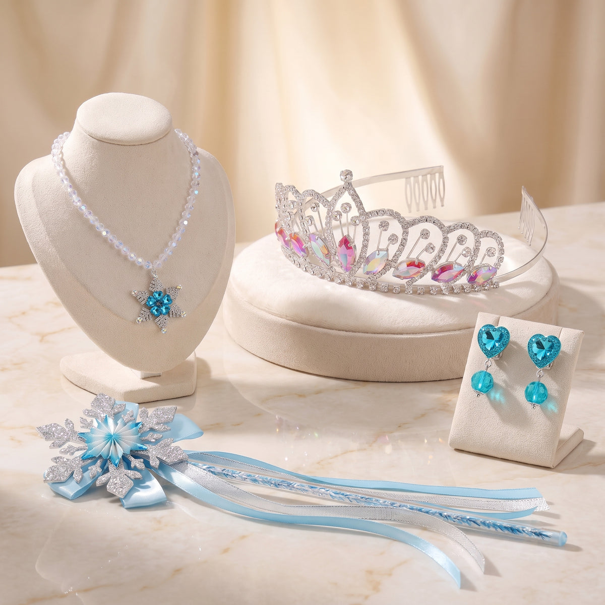 Ice Queen Jewelry Set flat lay: snowflake pendant necklace, rhinestone tiara, aqua heart clip-on earrings and glitter snowflake wand