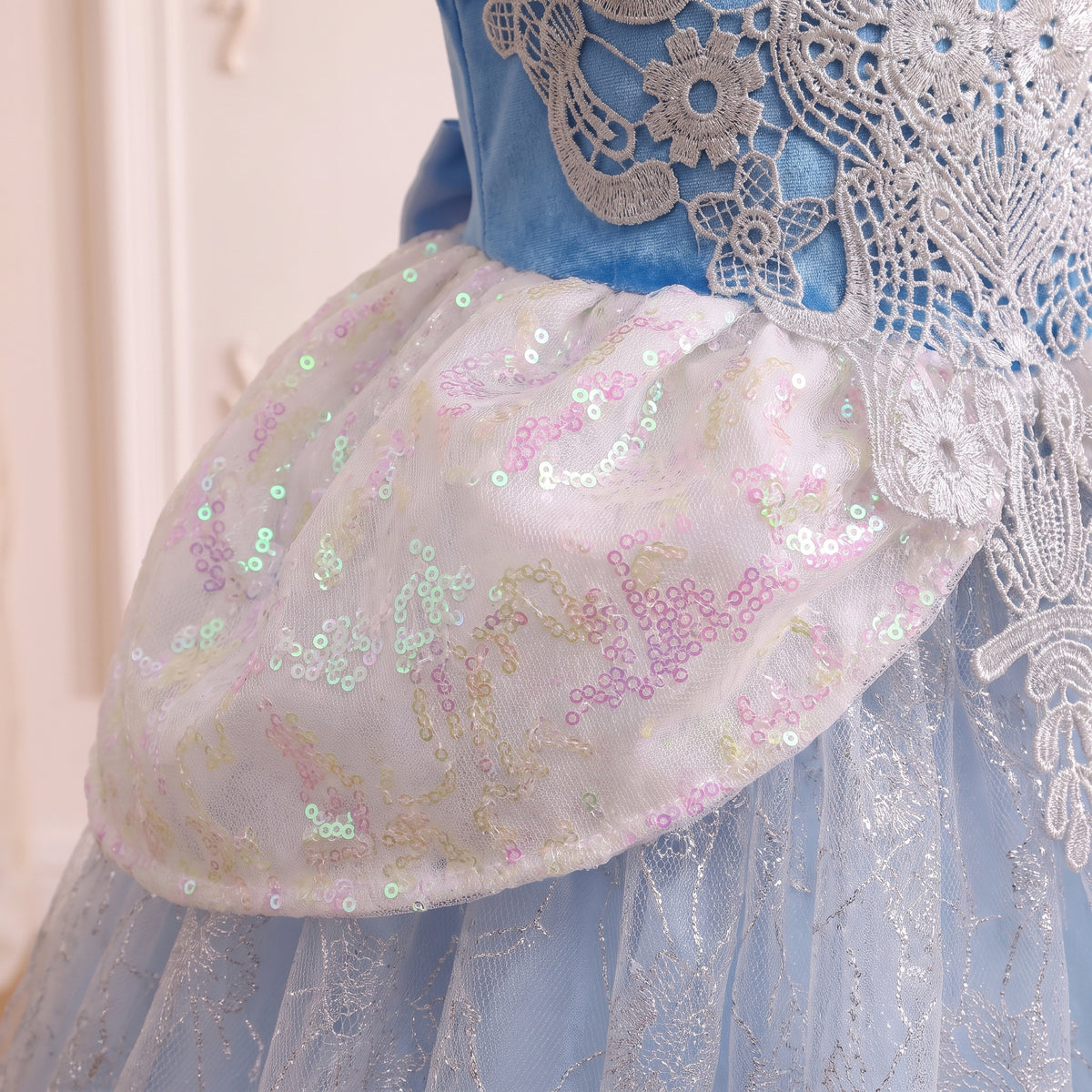 Close up of the iridescent sequin peplum panel at the waist of the Cinderella gown