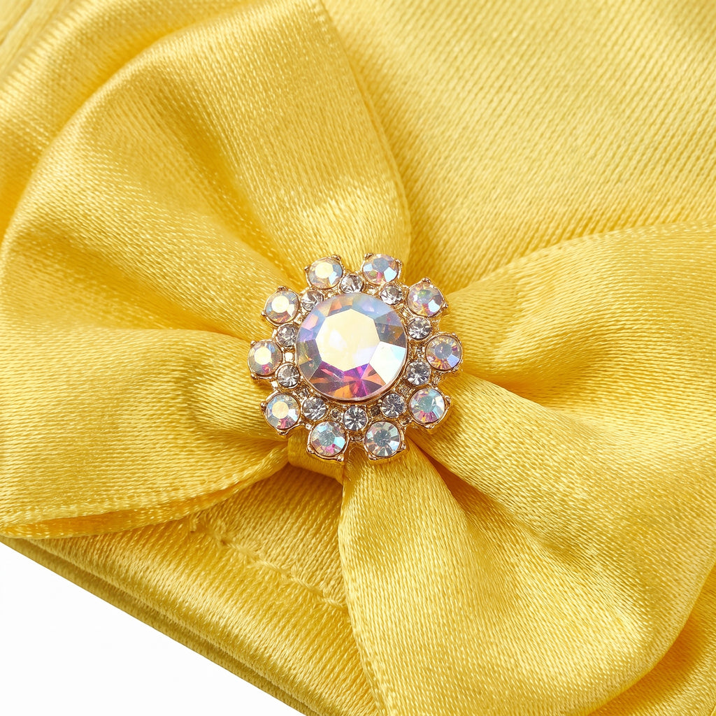 Close up of the satin bow and rhinestone button on the glove cuff