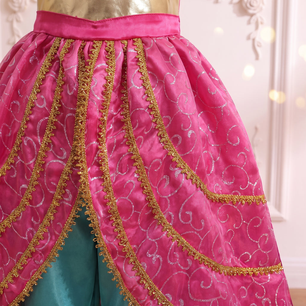 Close up of the gold braid trimmed overskirt tiers opening over the teal satin harem pants