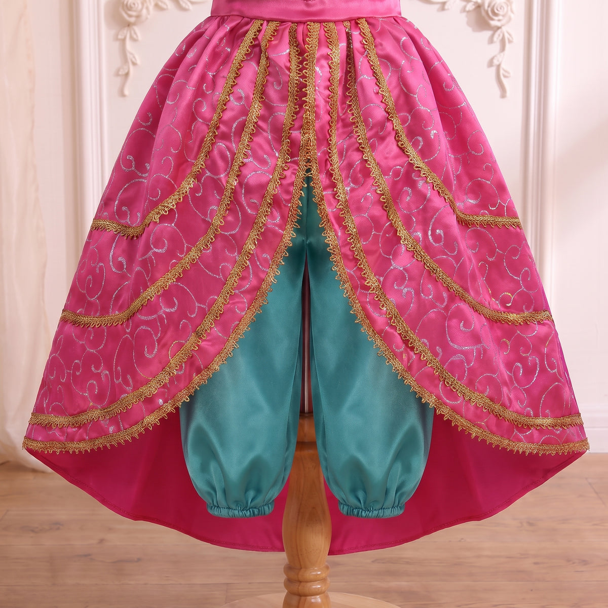 Close up of the high-low front opening and the gathered ankle cuffs of the teal harem pants
