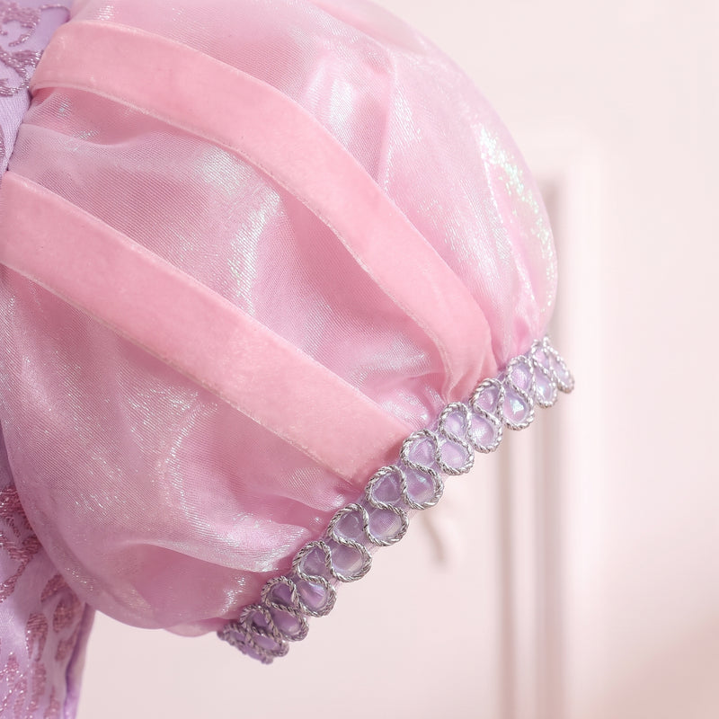 Close up of a sheer pink puff sleeve with ribbon stripes and a silver sequin cuff on the Rapunzel gown