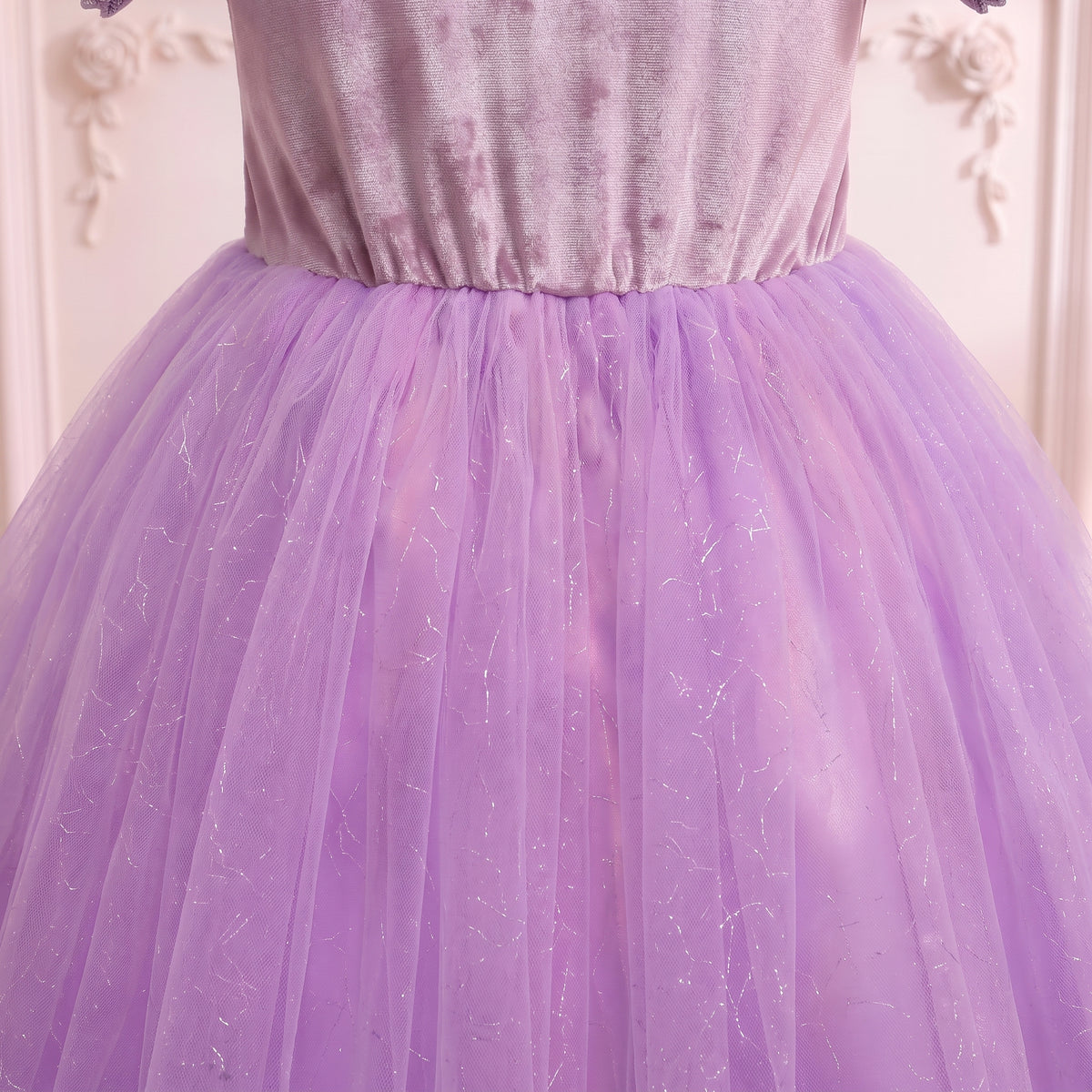 Close up of the pointed waist where the lavender glitter tulle skirt gathers on the Rapunzel gown