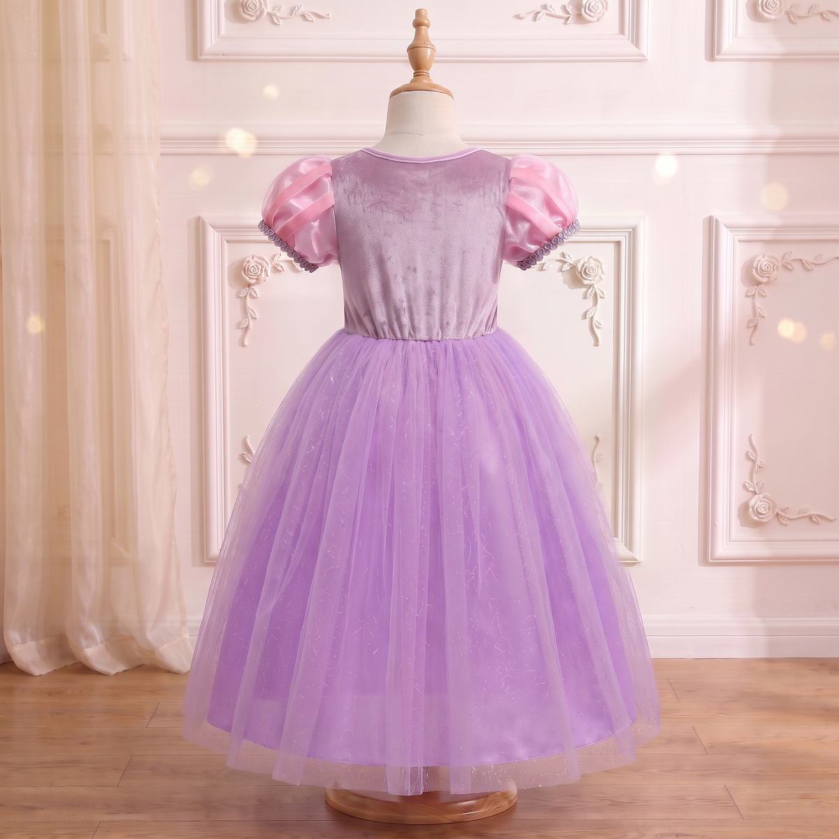 Back view of the Rapunzel Lavender Tower gown on a mannequin: smooth lilac back bodice and full lavender tulle skirt