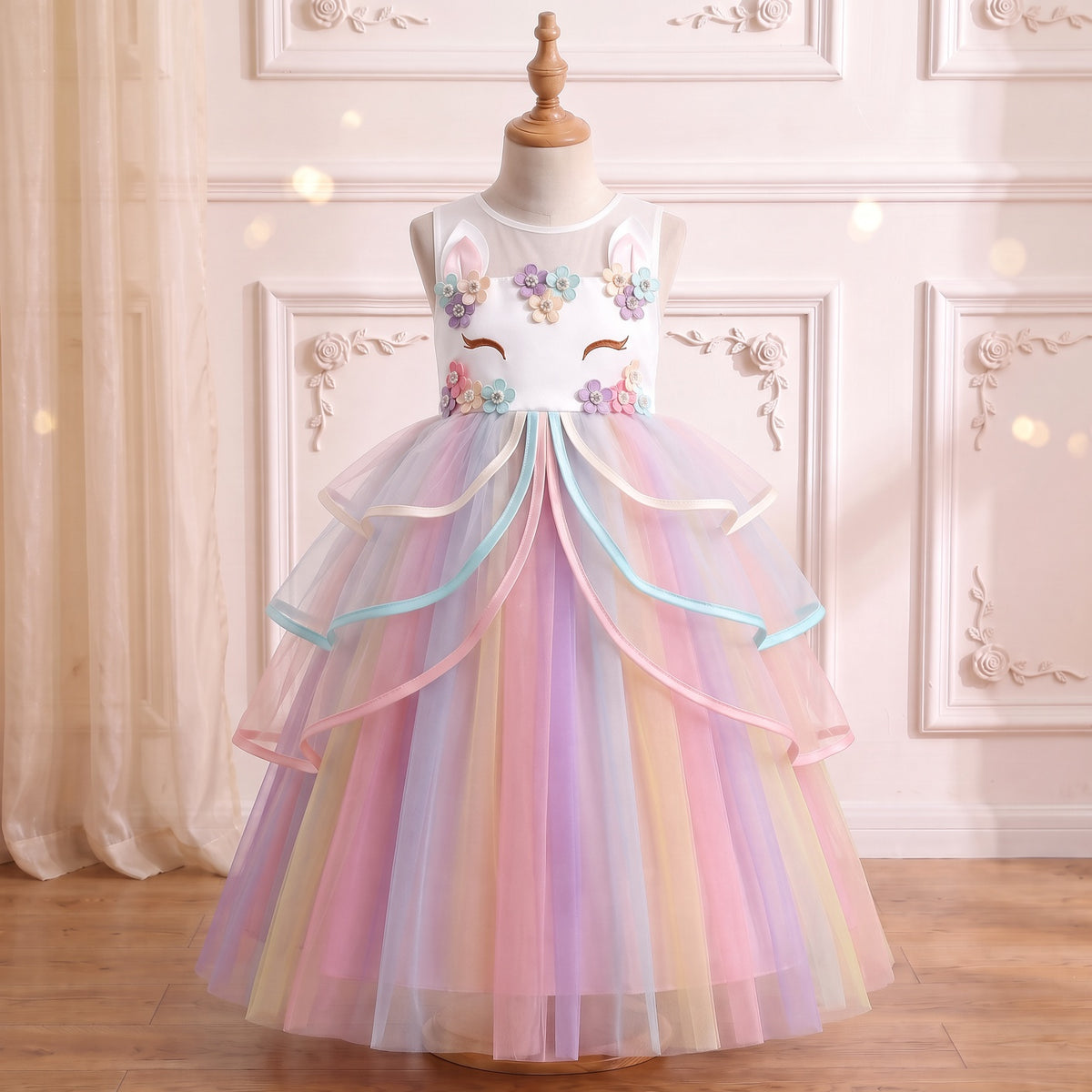Front view of the White Rainbow Unicorn Ribbon Gown on a mannequin: unicorn-face bodice, ribbon-edged ruffles, rainbow tulle skirt