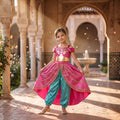 Girl in a pink and gold Arabian princess dress with teal harem pants in a palace courtyard