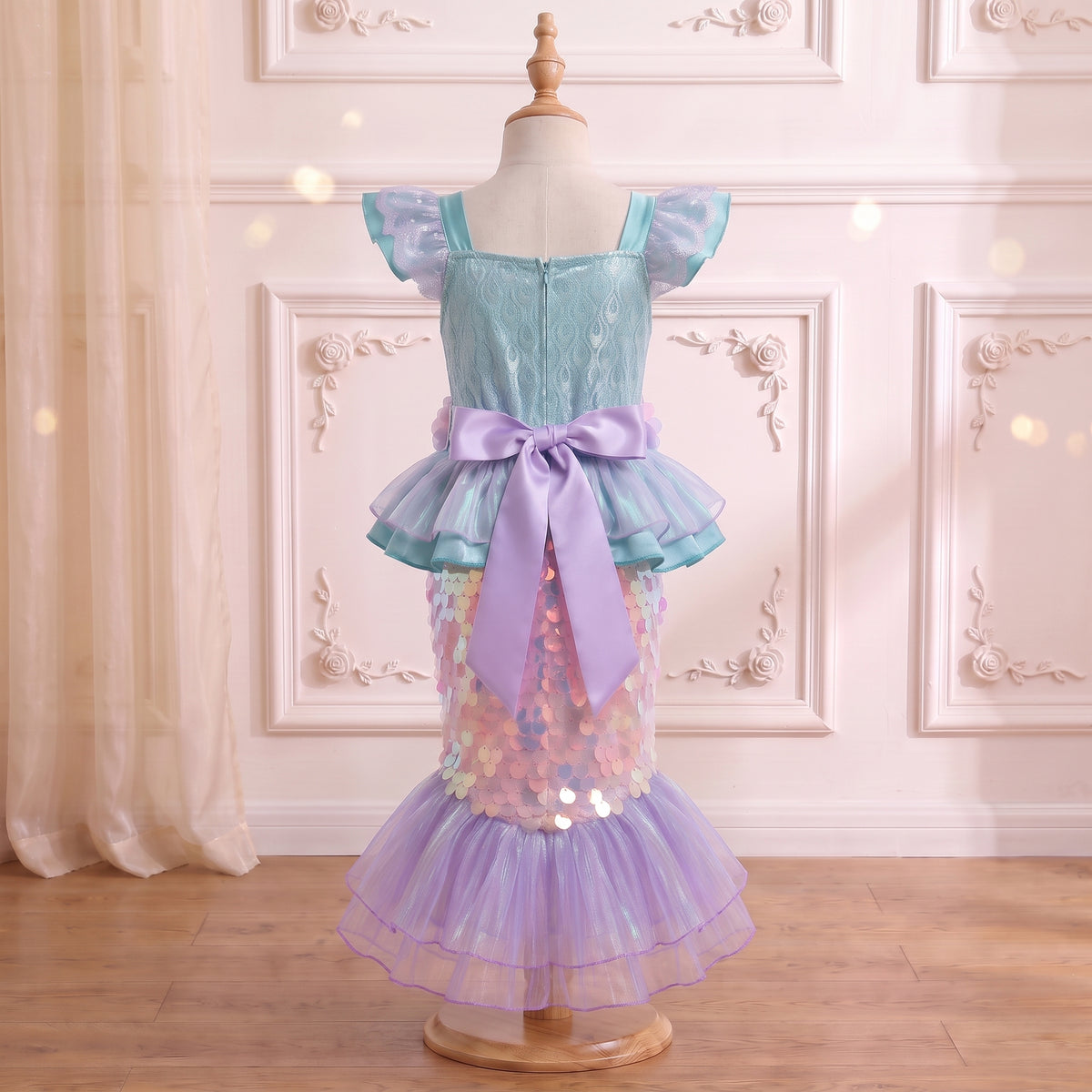 Back view of the Little Mermaid Shimmering Gown on a mannequin with the lilac satin bow