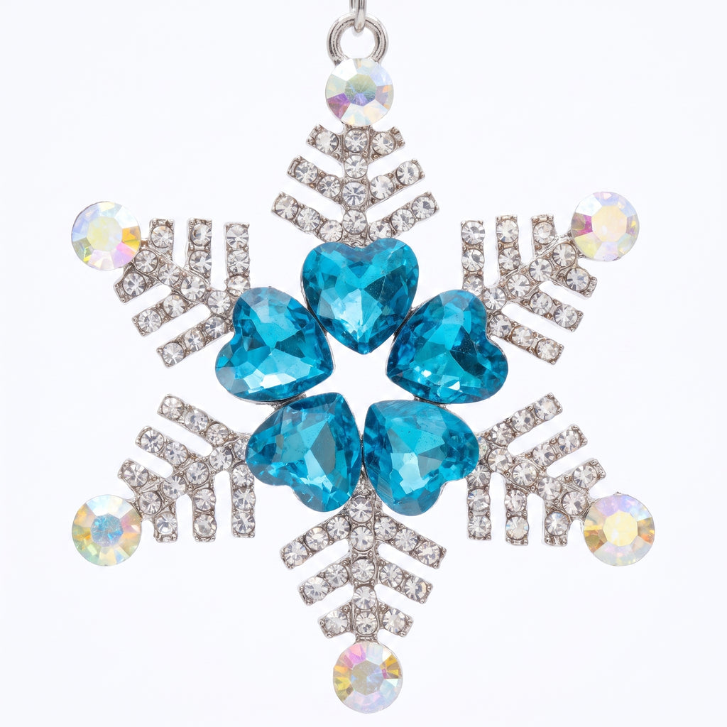 Close up of the snowflake pendant: five aqua heart stones ringed in rhinestones