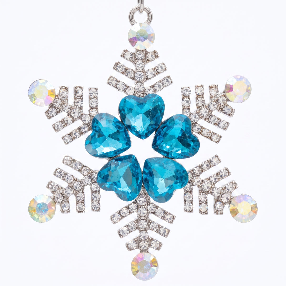 Close up of the snowflake pendant: five aqua heart stones ringed in rhinestones