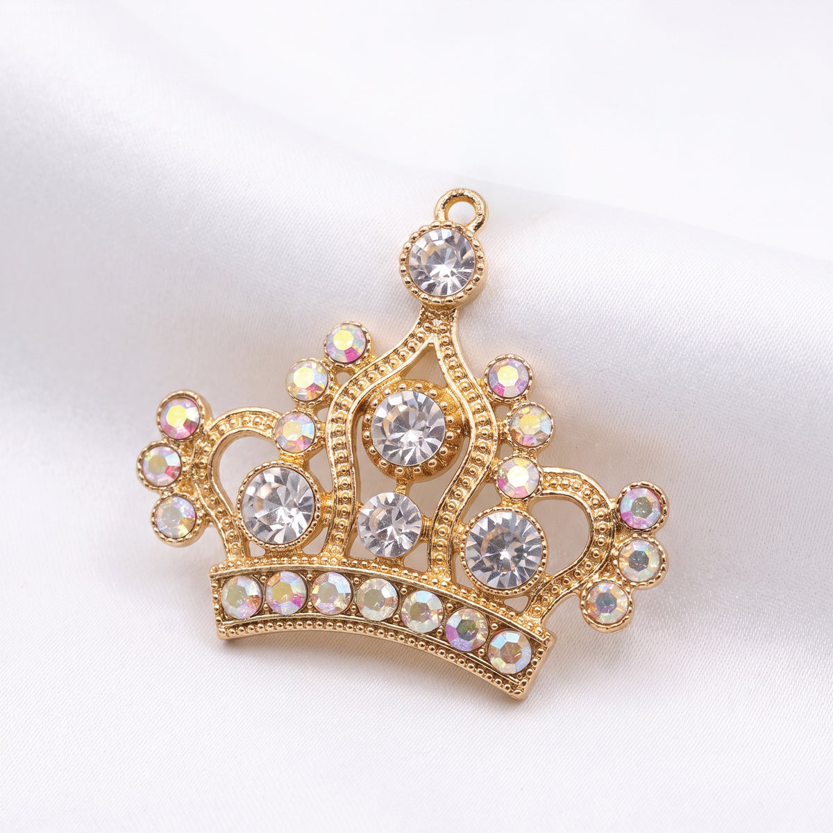 Gold crown pendant set with clear and iridescent rhinestones
