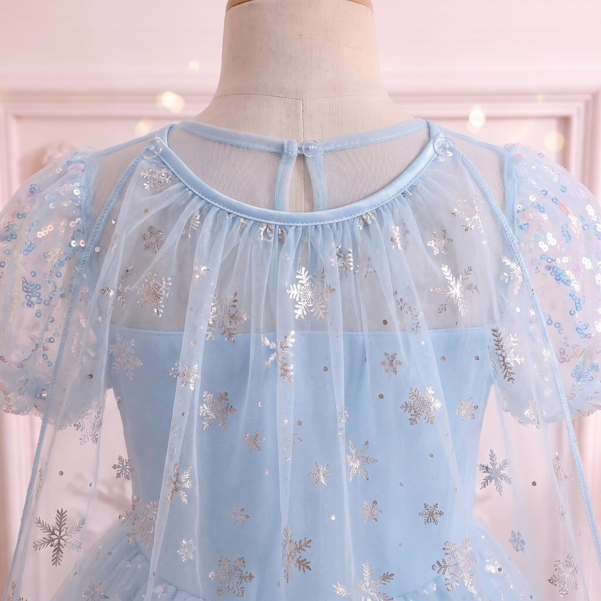 Back view of the sheer yoke and shoulders where the snowflake cape attaches