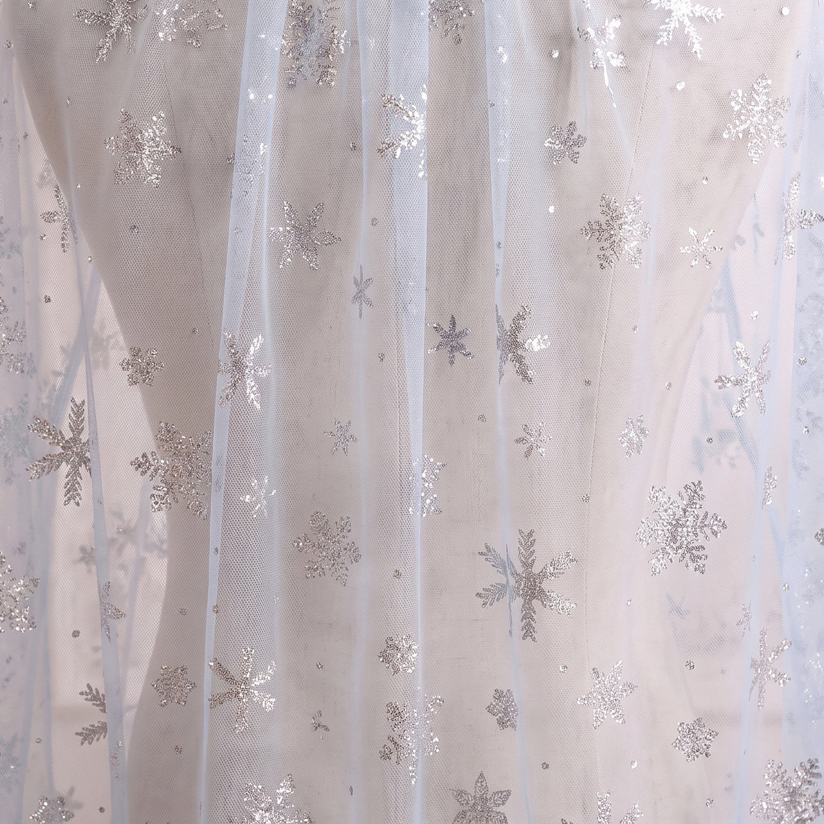 Close up of the sheer cape with silver snowflakes