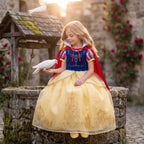 Castle Cape Dress — shown in a storybook courtyard