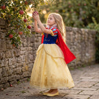 Castle Cape Dress — shown in an orchard