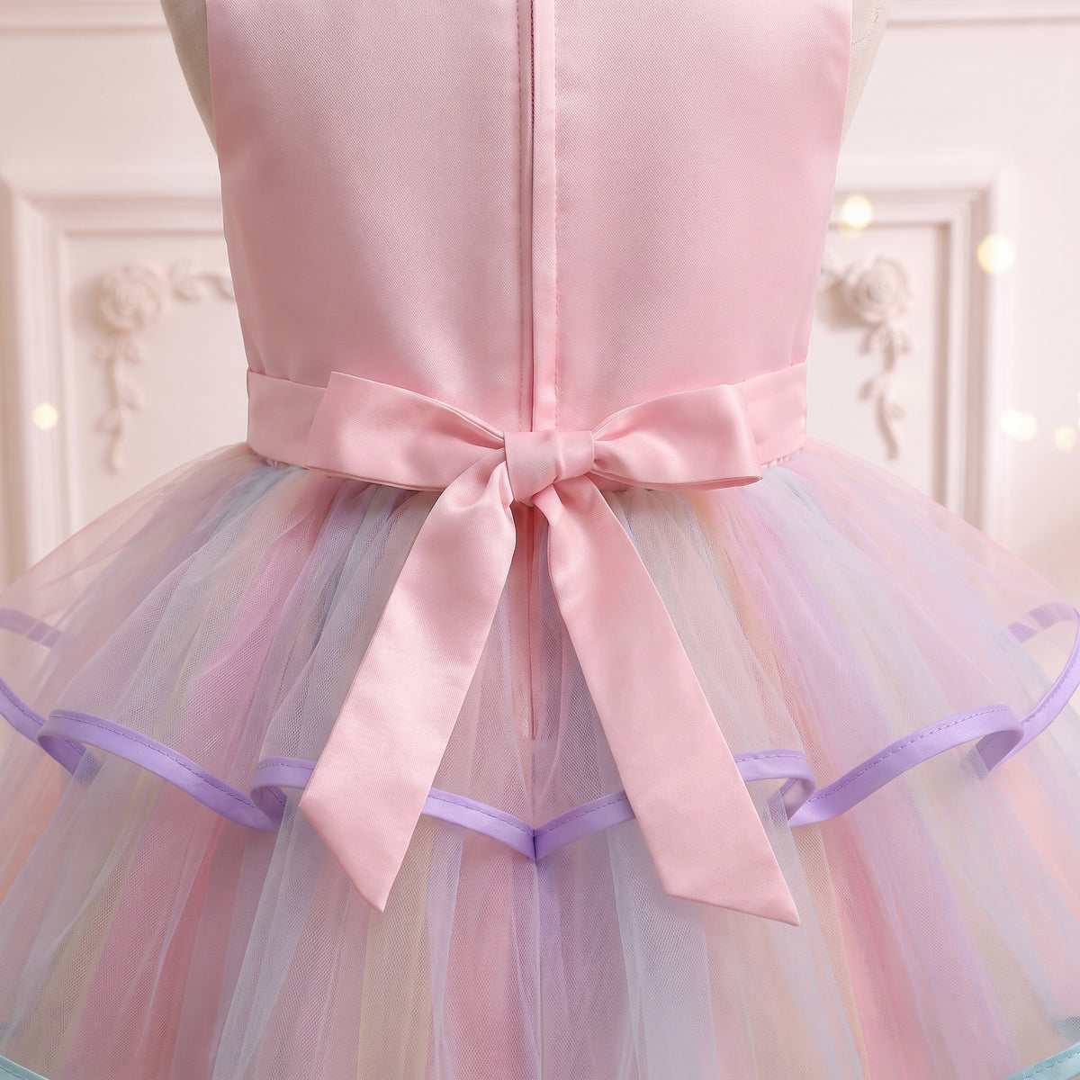 Close up of the pink satin bow with long streamers at the back waist