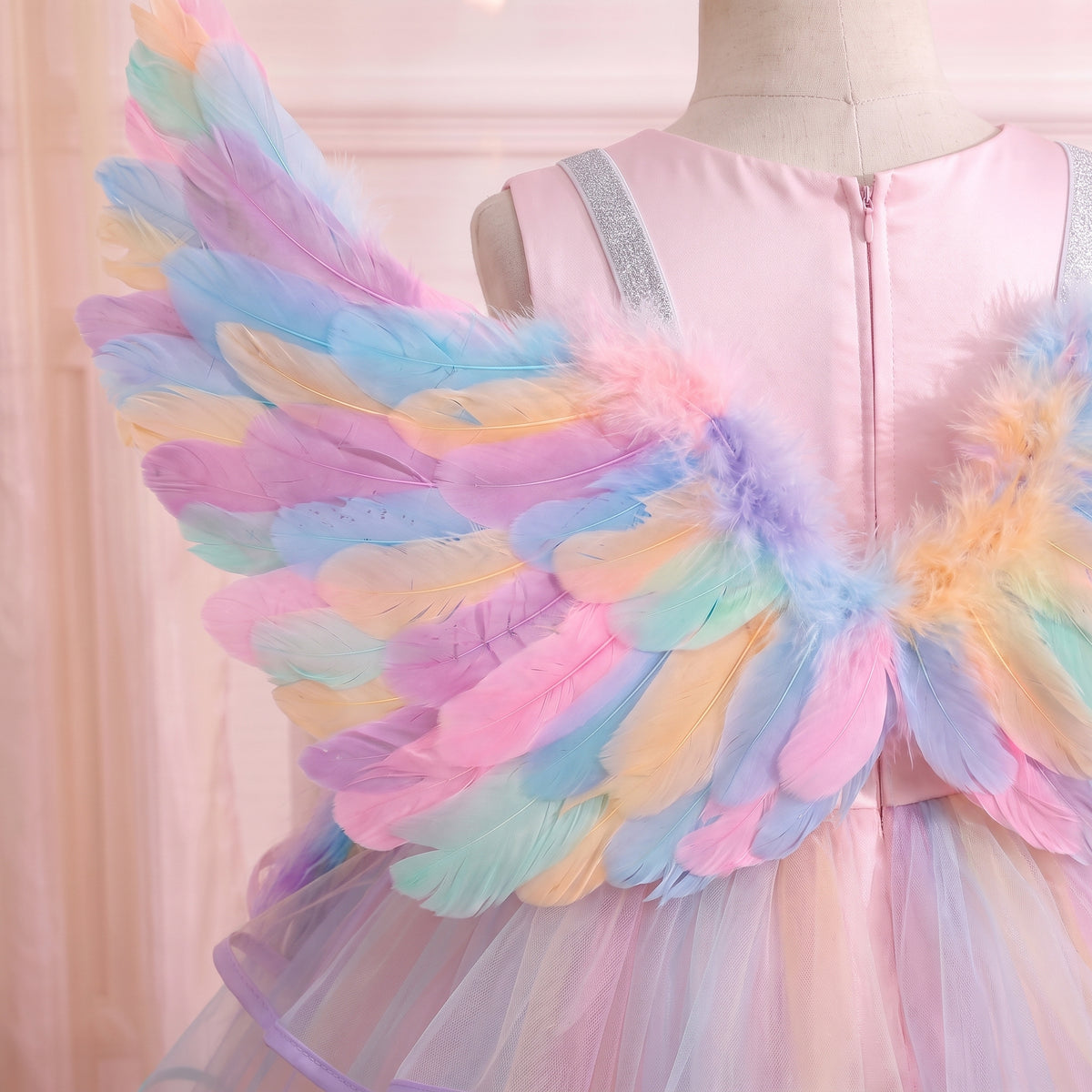 Close up of the pastel feather wings worn over the back zipper and sparkle shoulder straps