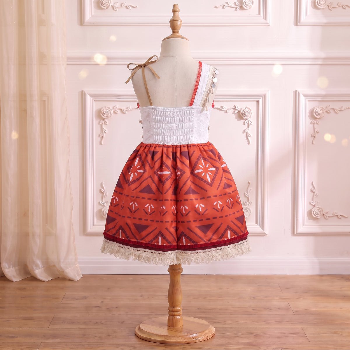 Back view of the dress showing the smocked stretch panel and suede ribbon shoulder tie