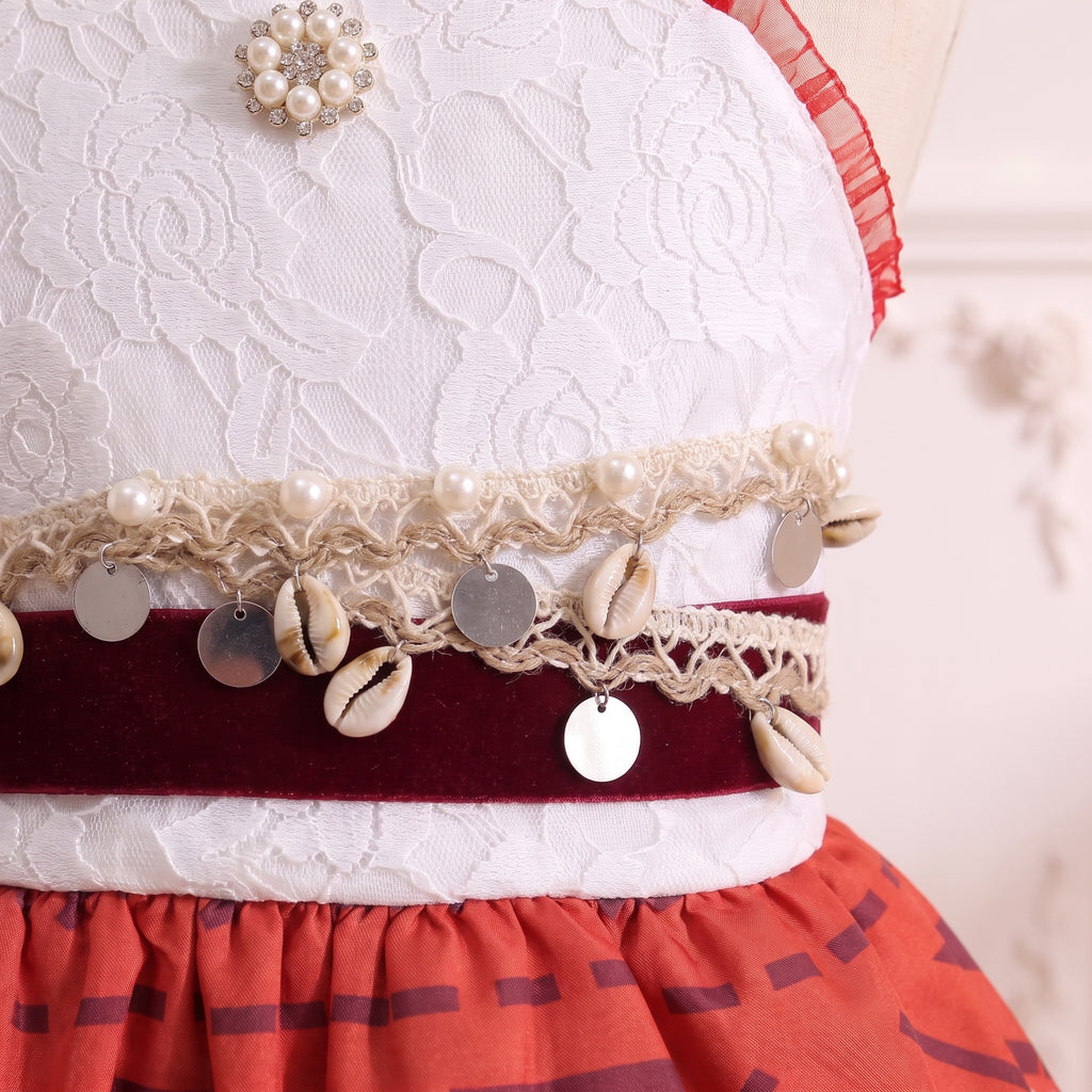Close up of the burgundy velvet belt with cowrie shells, shell coins, and pearl crochet braid