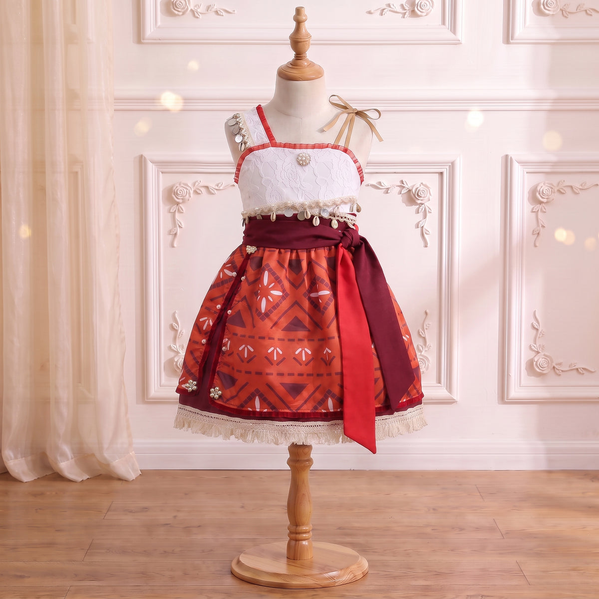 Front view of the island princess wayfinder dress with lace bodice, shell belt, split overskirt, and side sash