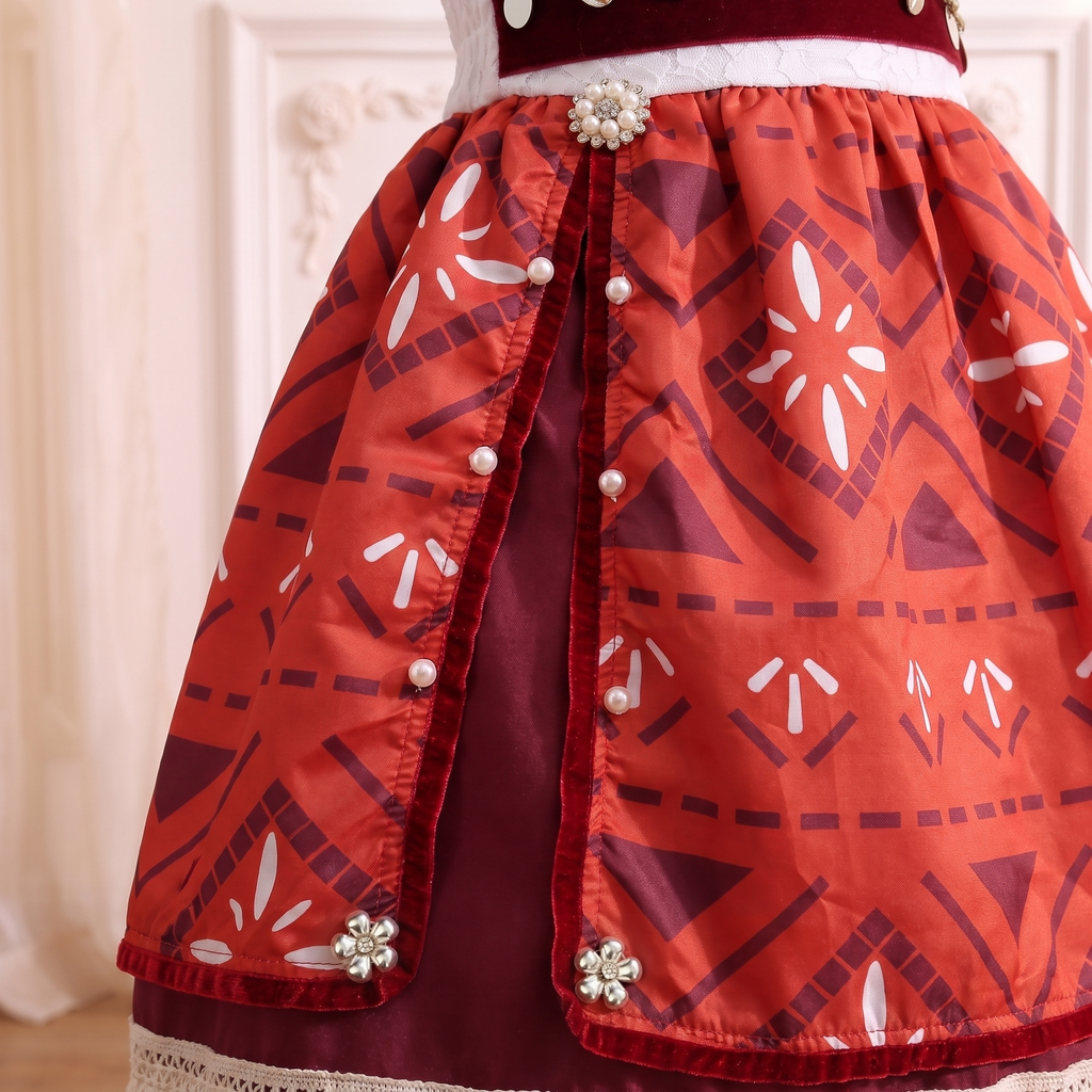 Close up of the split velvet edged tapa print overskirt dotted with pearls and crystal blooms