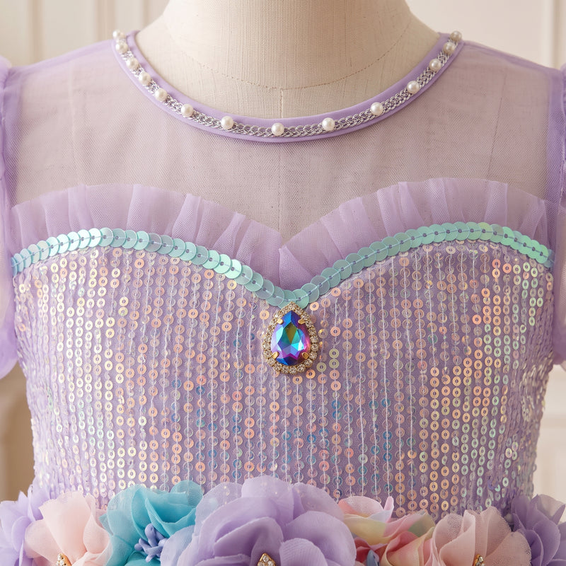 Close-up of the sequined bodice, teardrop jewel accent and pearl-style neckline trim