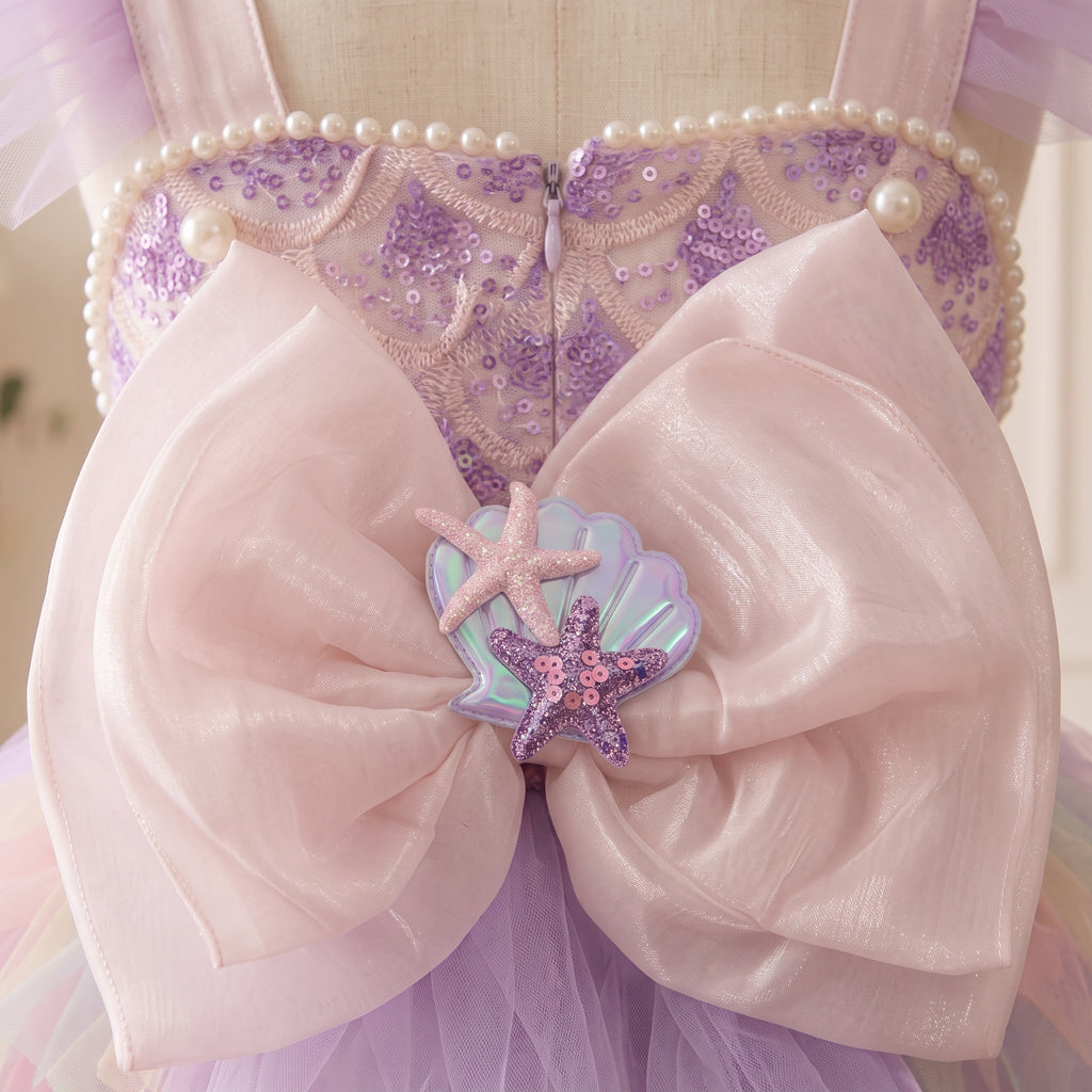 Blush back bow with an iridescent seashell and pink and purple starfish