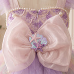Blush back bow with an iridescent seashell and pink and purple starfish