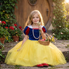 Snow White Tulle Dress — shown seated in a garden